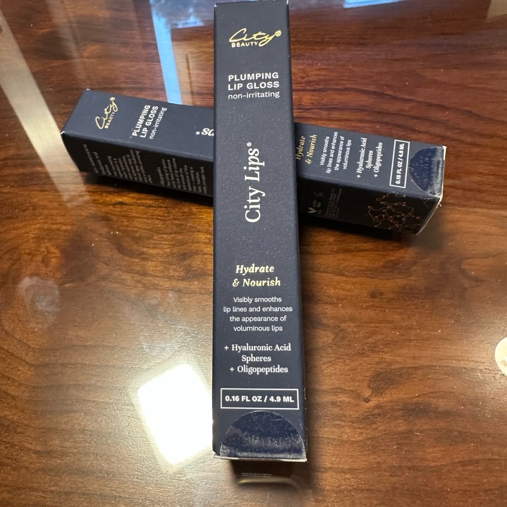 New, sealed package - Plumping Lip Gloss - Clear